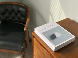 Elegant law books and a gavel on a dark wooden desk illuminated by soft light.