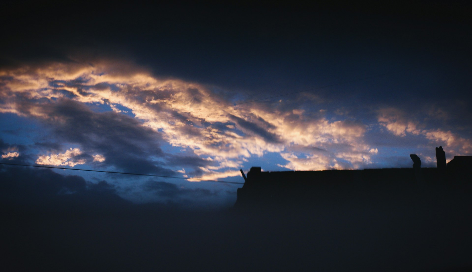 woman wearing yellow long-sleeved dress under white clouds and blue sky during daytime