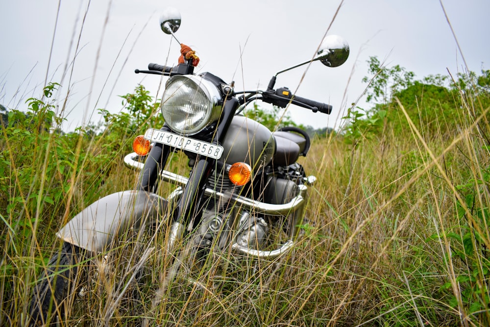 black and silver cruiser motorcycle on green grass field during daytime