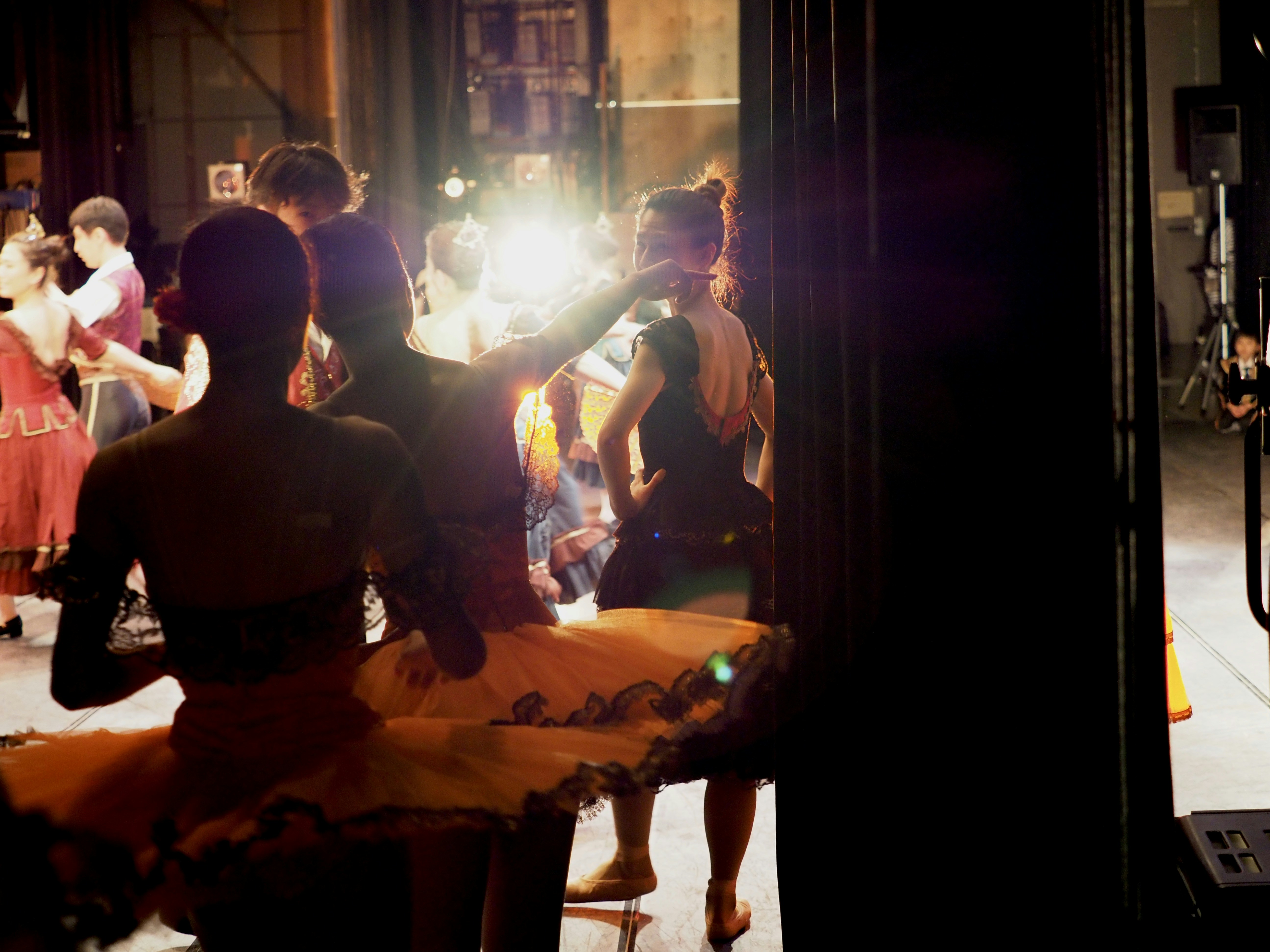 man in black t-shirt and black pants standing beside woman in black t-shirt