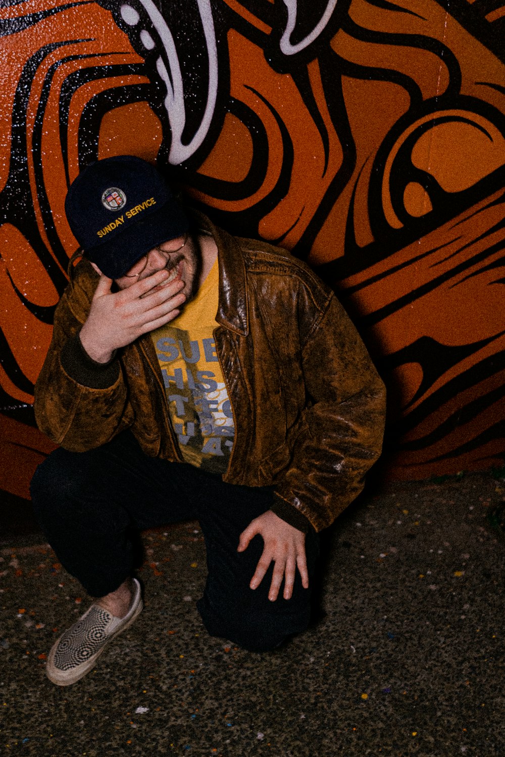 man in brown jacket and black knit cap