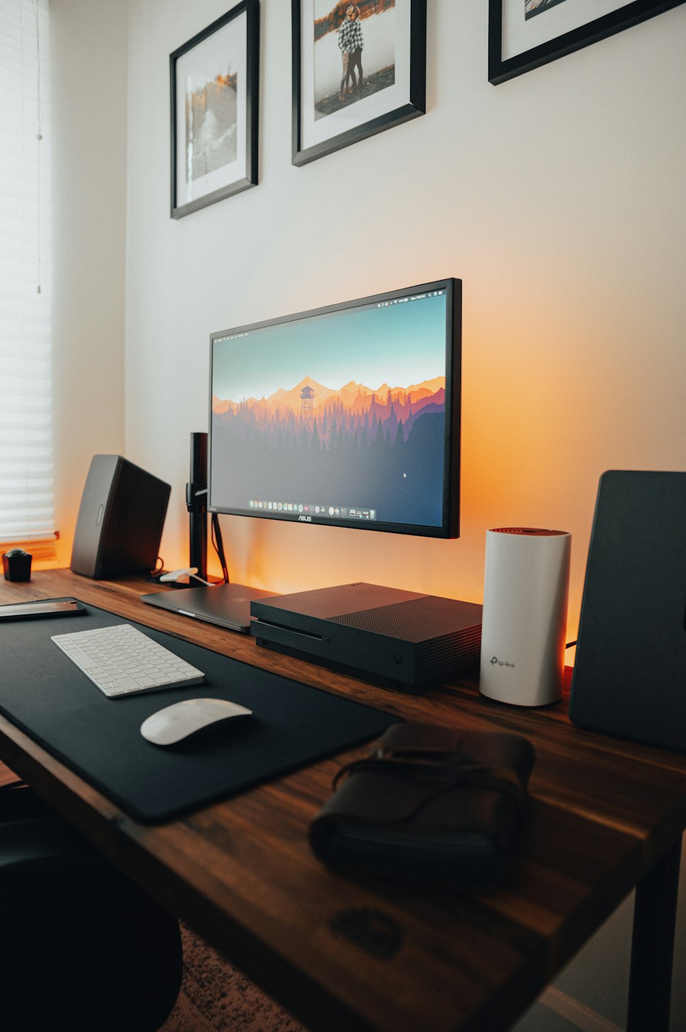 black flat screen tv turned on beside black and silver laptop computer