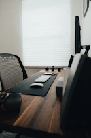 A modern office desk with electronic furniture accessories neatly arranged on top.