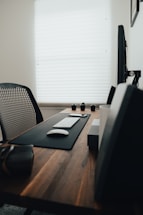 Modern office desk with computer, phone, and stationery neatly arranged