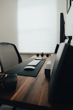 A modern office desk with various computer hardware and accessories neatly arranged.