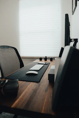 A modern office desk with various computer hardware and accessories neatly arranged.