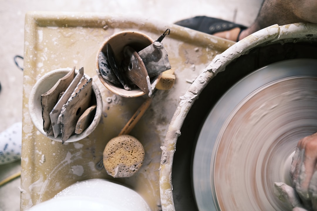 Working with stoneware clay on a Brent wheel.