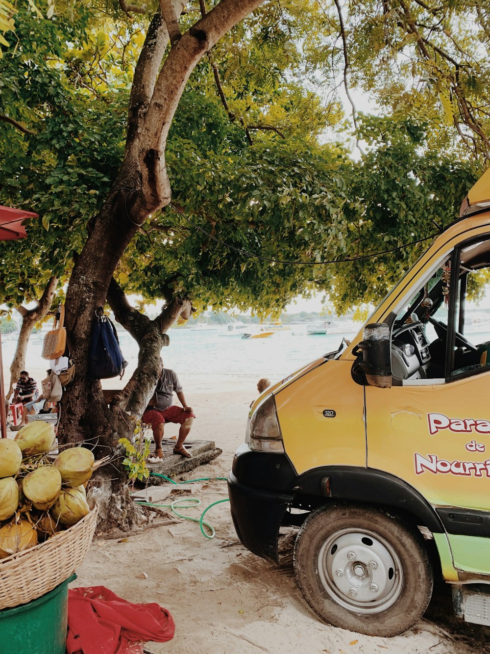 yellow and black auto rickshaw near people on beach during daytime