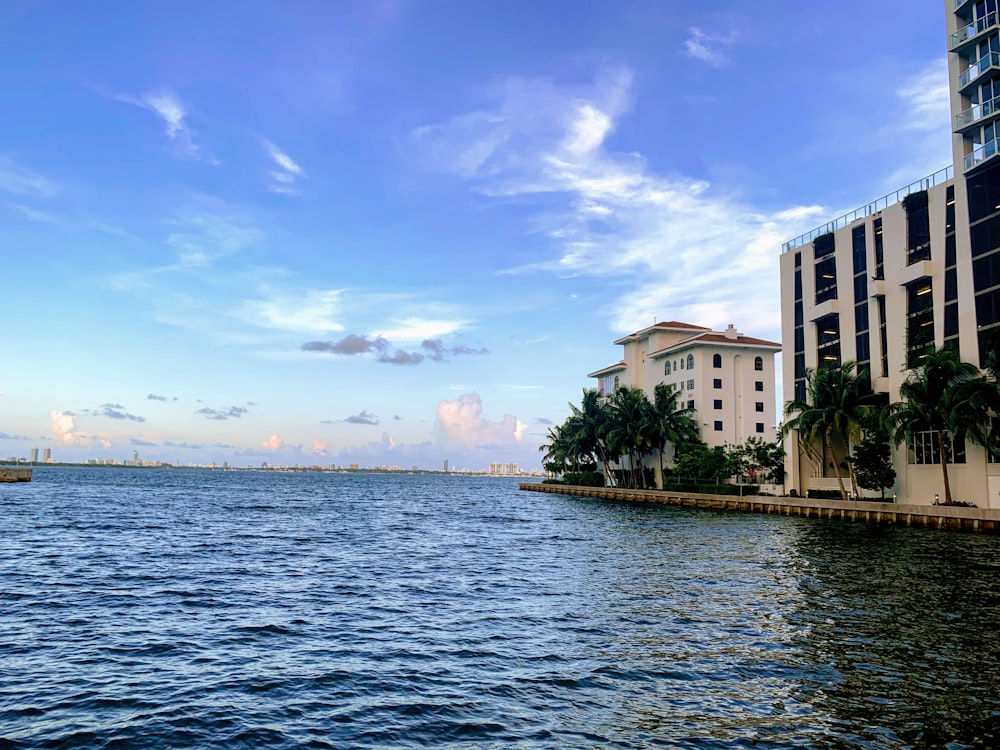 white concrete building near body of water during daytime