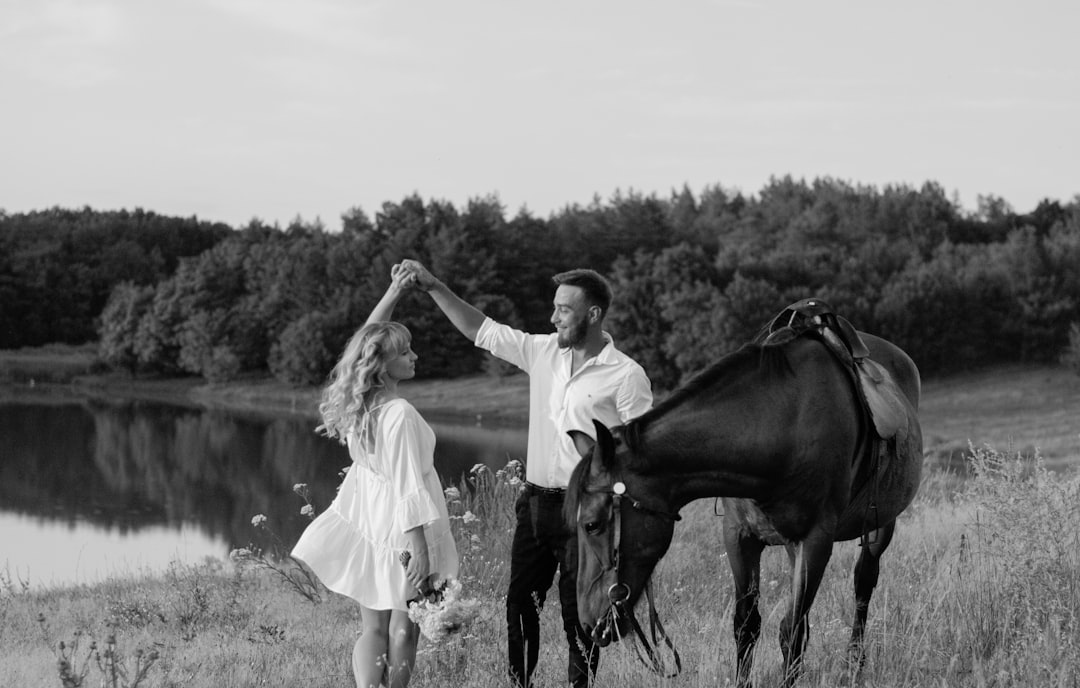 grayscale photo of girl and boy riding horse