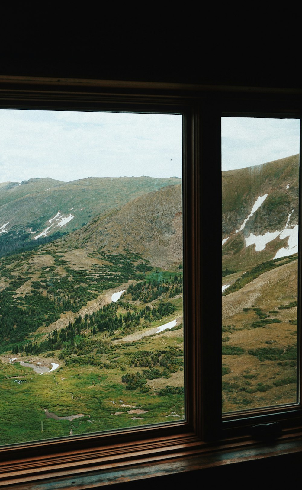 green and brown mountains under white sky during daytime