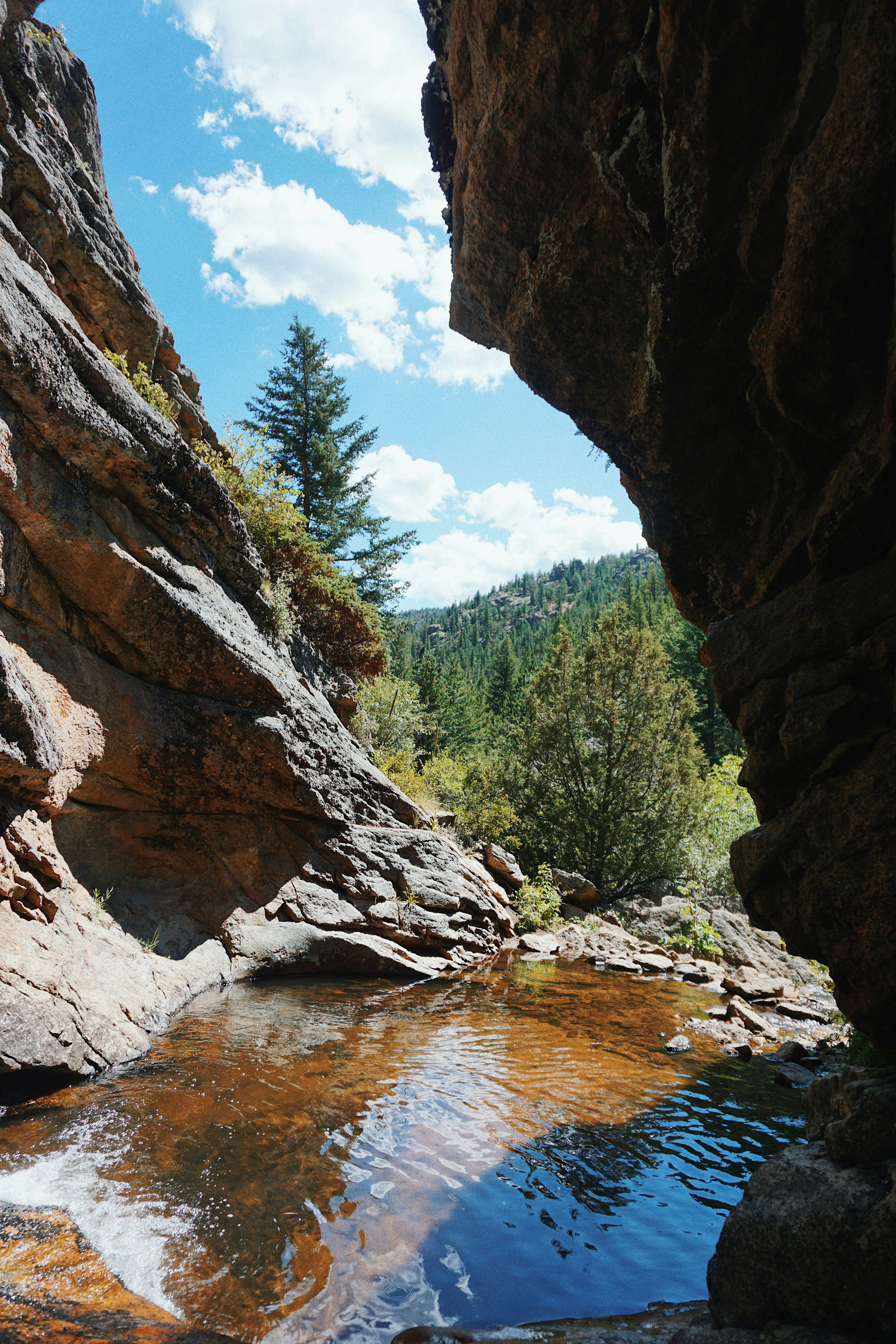 brown rocky mountain near river during daytime