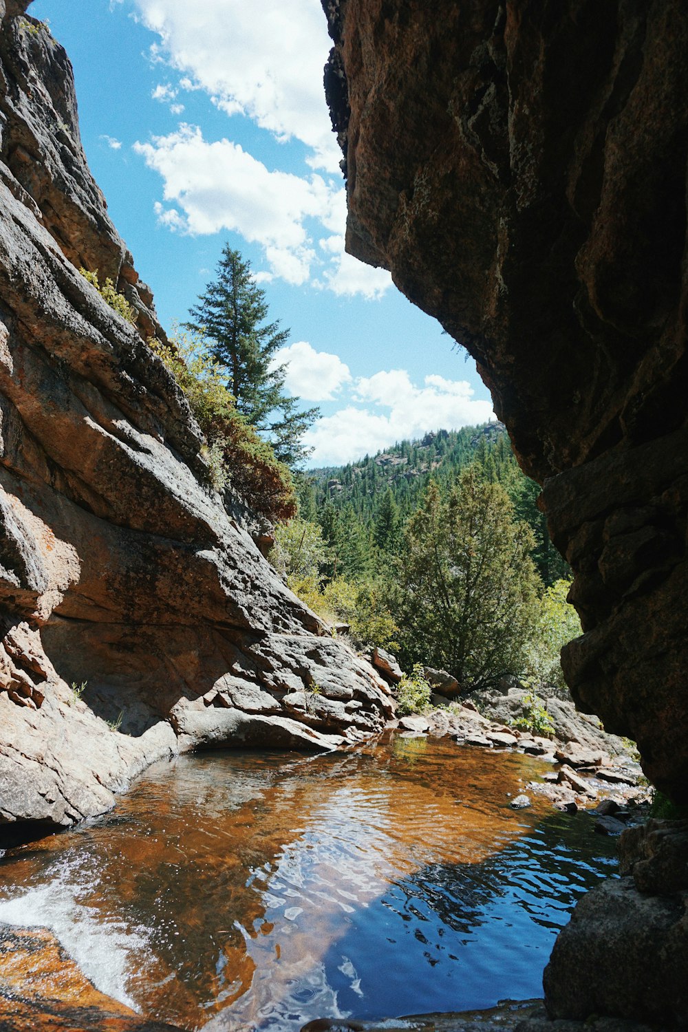 brown rocky mountain near river during daytime