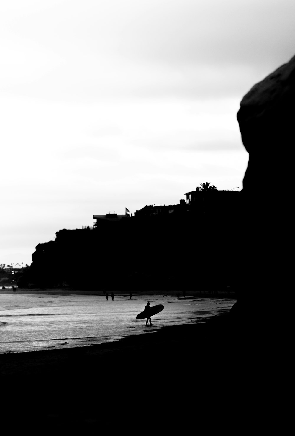 grayscale photo of people walking on beach