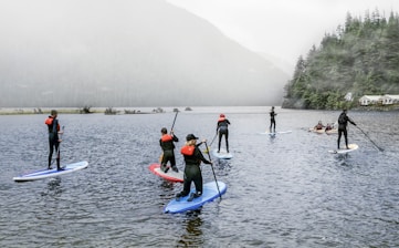 people riding on blue kayak on body of water during daytime