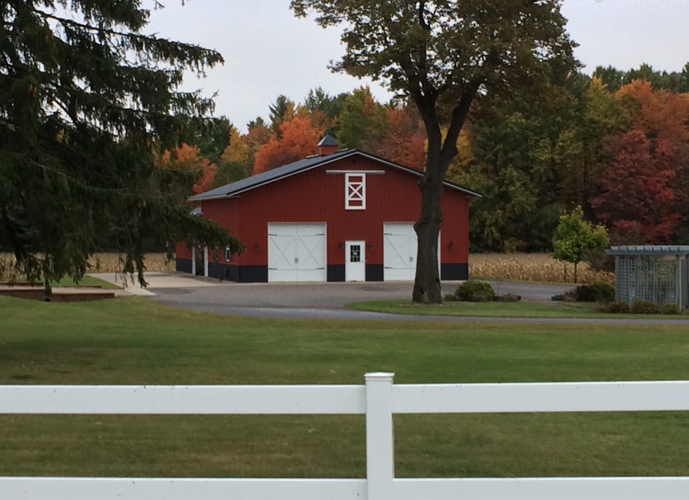 red and white house near green trees during daytime