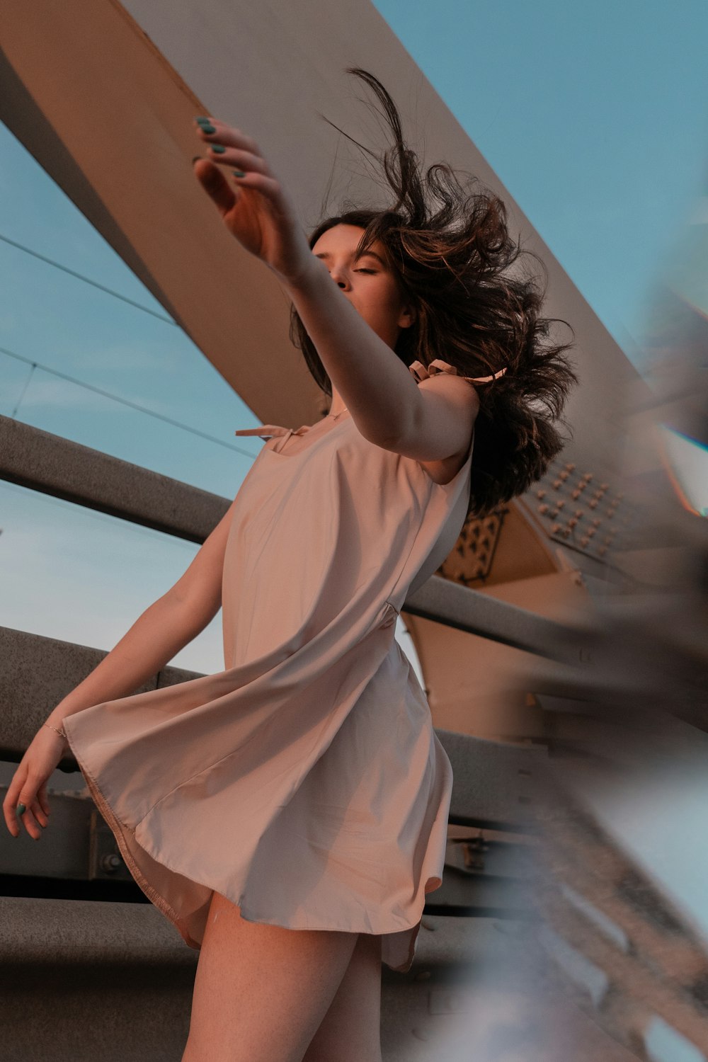 woman in white dress standing on gray concrete floor during daytime