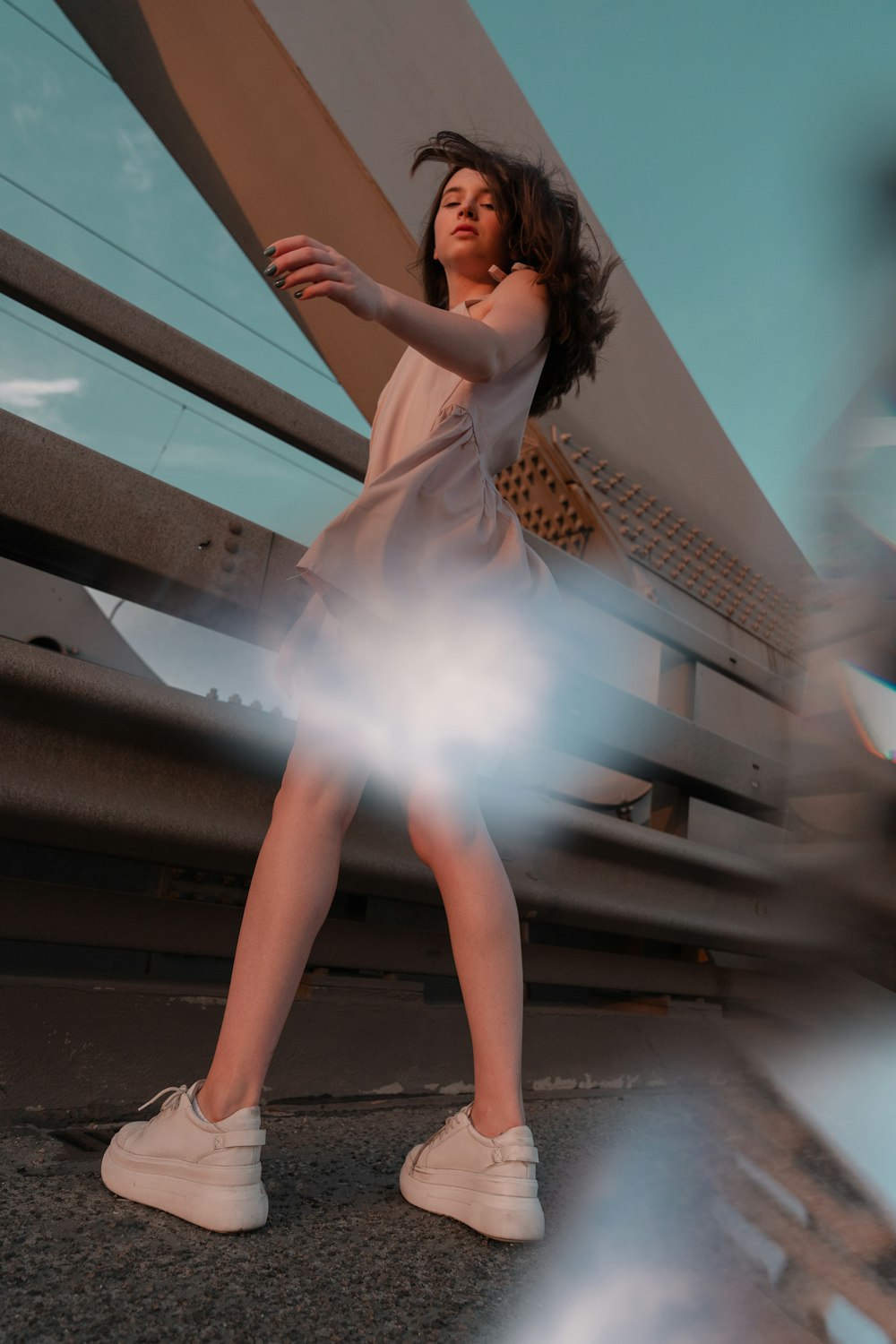 woman in white dress standing on stairs