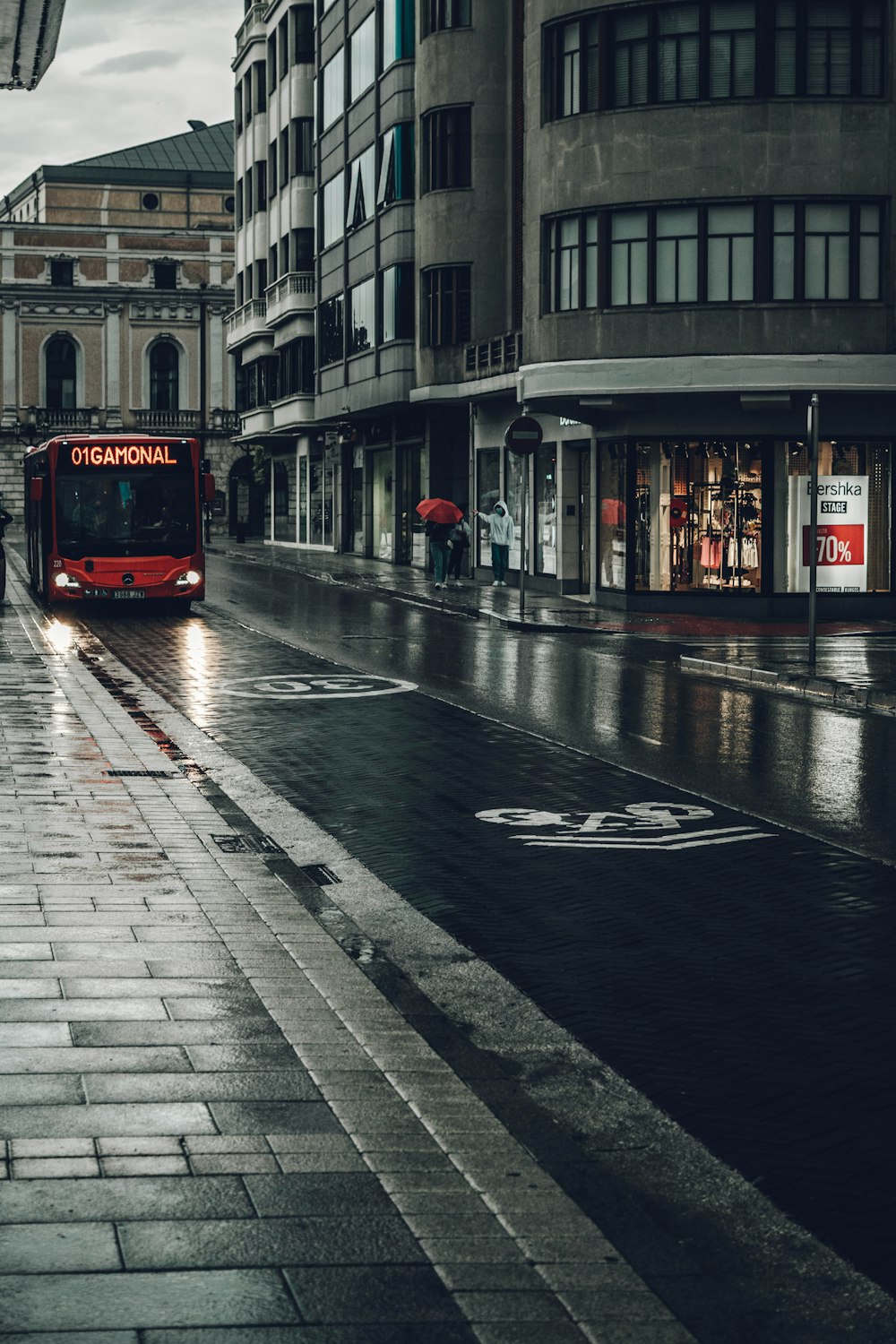 red tram on road near building during daytime