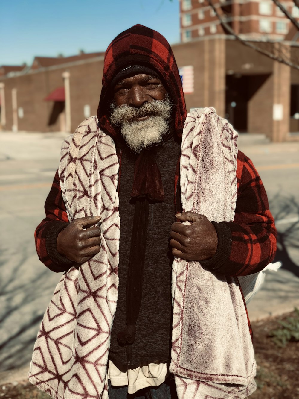 man in red and black coat standing during daytime