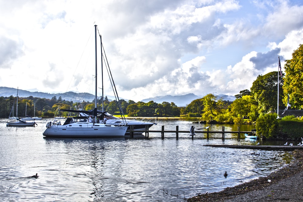 white boat on body of water during daytime