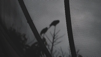 Asymmetrical masonry grid layout showing a mix of fabric textures and street-ready silhouettes in low light.