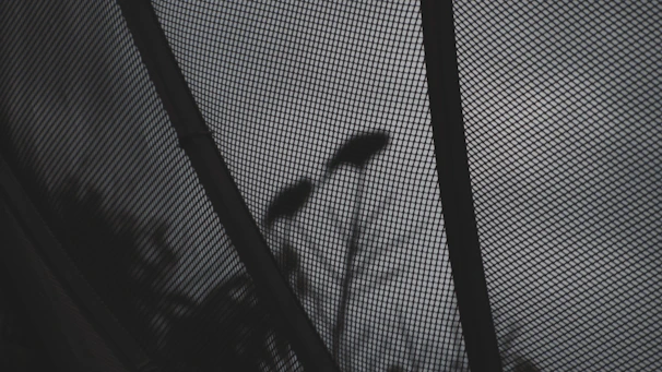 Asymmetrical masonry grid layout showing a mix of fabric textures and street-ready silhouettes in low light.