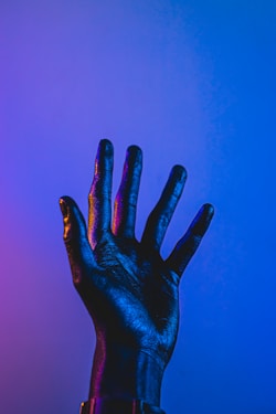 persons hand with blue paint