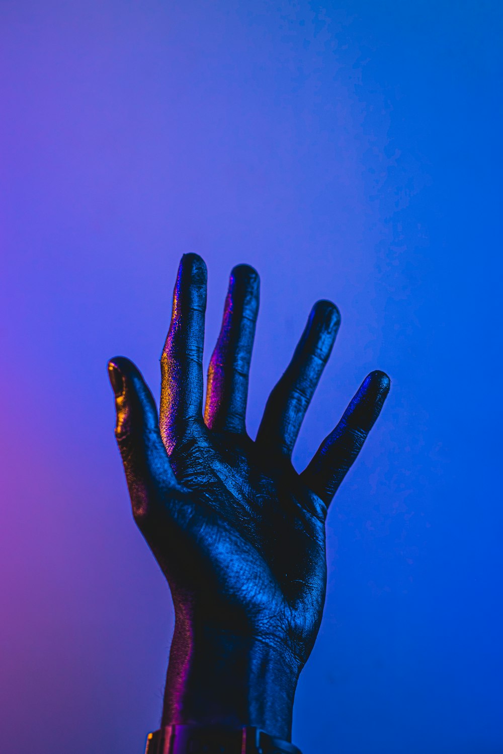 persons hand with blue paint