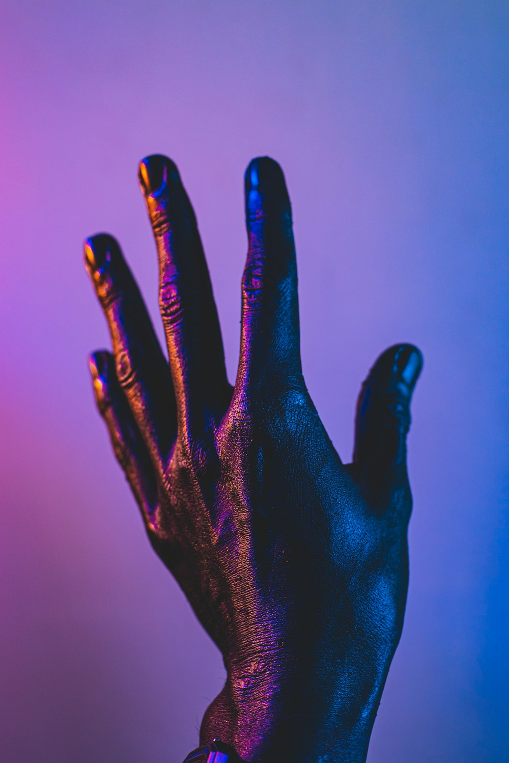 persons left hand with blue manicure