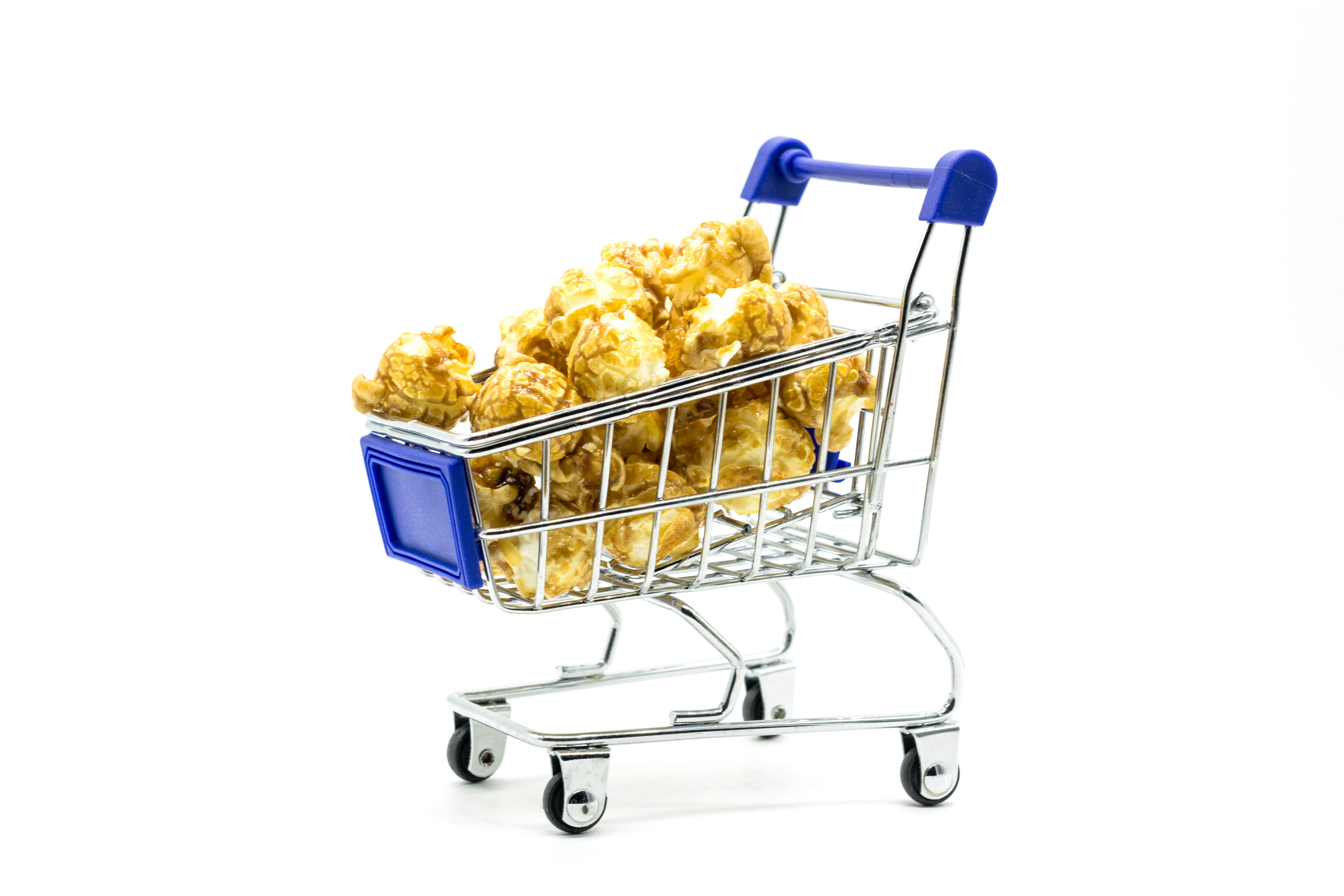 Shopping trolley toy full of popcorn on white background minimal concept. Instagram - @bermixstudio | Donation https://paypal.me/bermixclub Goal: $0 of $100 - any amount appreciated 🤘