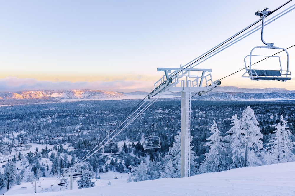 cable cars over snow covered mountain during daytime