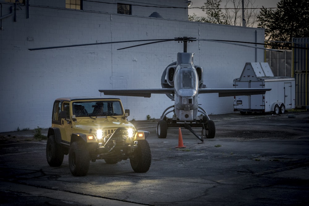 yellow and black heavy equipment on gray asphalt road during daytime