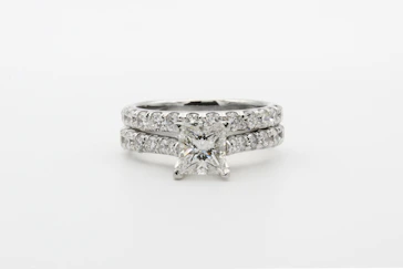 silver diamond studded ring on white surface