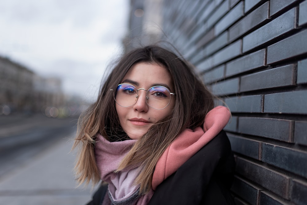 woman in black coat wearing black framed eyeglasses