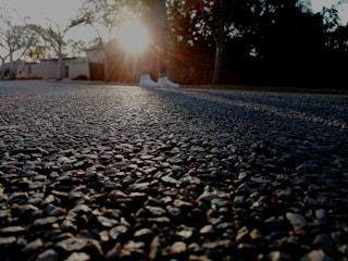 Evening shot of a driveway highlighting the resin flooring’s warm texture.