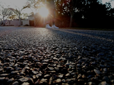 Evening shot of a driveway highlighting the resin flooring’s warm texture.