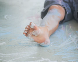 person in blue denim jeans with white powder on hand