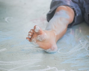 person in blue denim jeans with white powder on hand