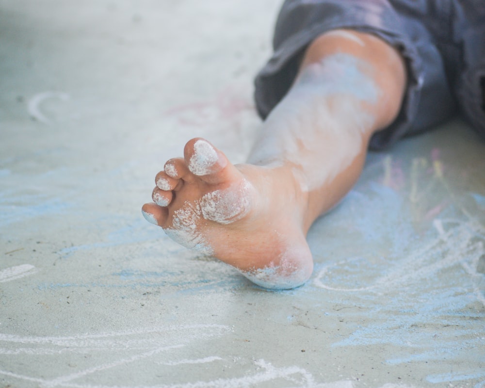 personne en jean bleu avec de la poudre blanche à portée de main