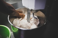 Close-up of a modern dough mixer in a bakery setting.