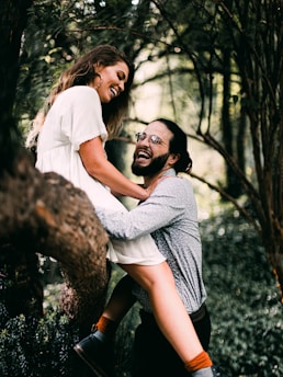man in white t-shirt hugging woman in white t-shirt
