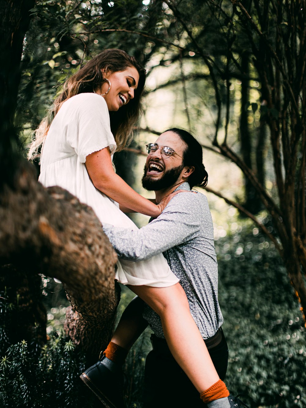 man in white t-shirt hugging woman in white t-shirt