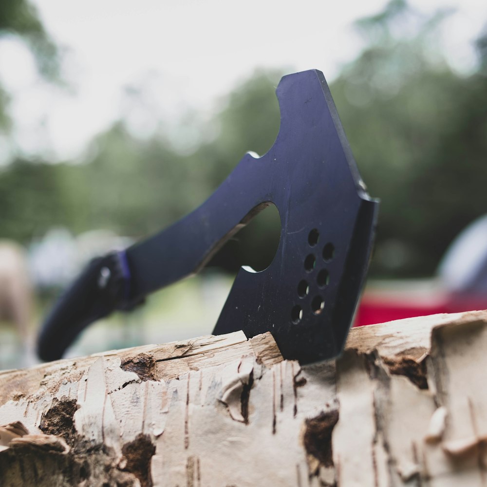 black and gray metal tool on brown wood