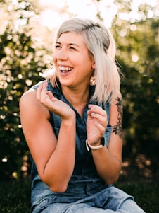 woman in black tank top smiling