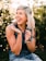 woman in black tank top smiling