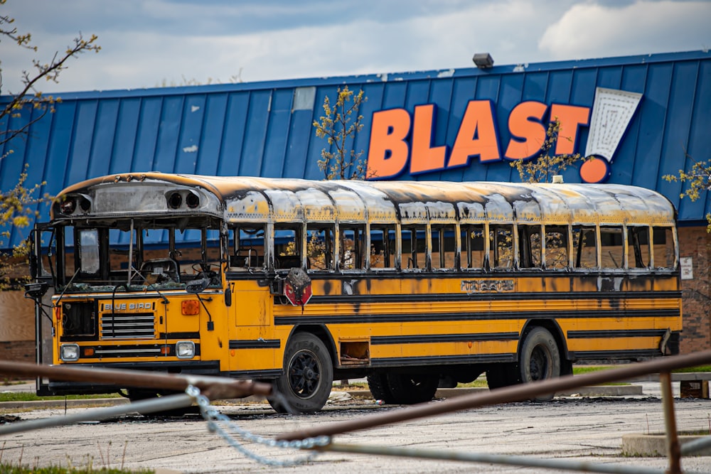 school bus parked near white building during daytime