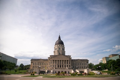 white concrete building under white clouds during daytime capital building zoom background