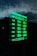A digital sign displays business hours in glowing green text against a dark background. The days of the week are listed, with varying opening hours from Tuesday to Saturday and closures on Sunday and Monday. The sky and part of a building are faintly visible in the reflection.