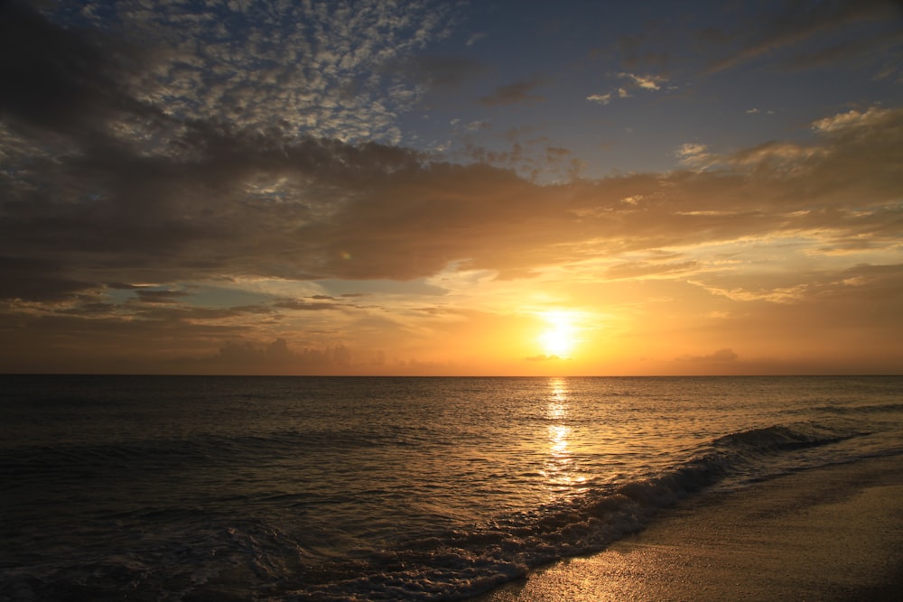 body of water during sunset